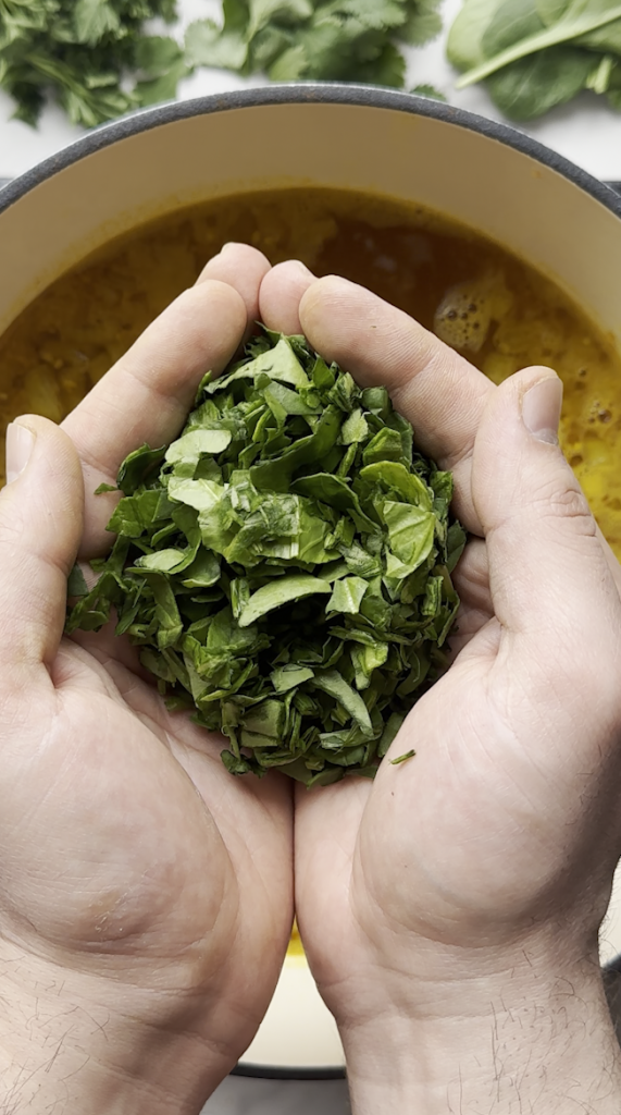 diced spinach going into the aush/ash pot